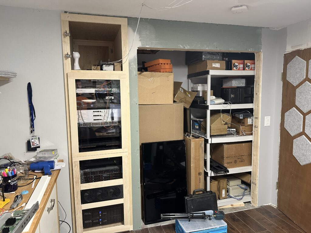 Picture of a new bedroom closet storage with a computer rack on the left.